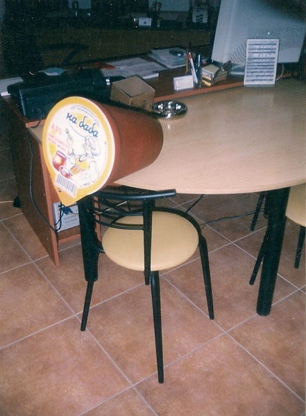 Mockup of a yogurt bucket scaled to the size of a chair and table