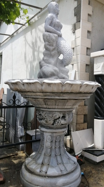 Gray marble mermaid figure fountain, side view