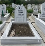 Muslim monument with crescent and star, inscription in carved black letters, pedestal, tiled curb, concrete base
