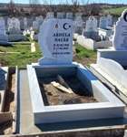 Muslim monument with crescent and star, colored elliptical porcelain photo, inscription in carved black letters, pedestal, tiled curb, concrete base