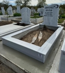 Muslim monument with crescent and star, wheel of life pattern, inscription in carved black letters, pedestal, tiled curb, concrete base