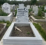 Muslim monument with crescent and star, inscription in carved black letters, pedestal, tiled curb, concrete base
